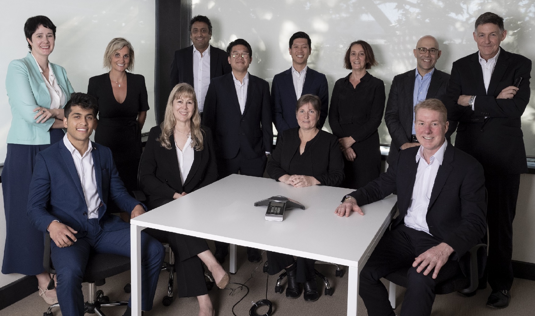 group photo of Augusta Australia Team sitting and standing in Sydney office