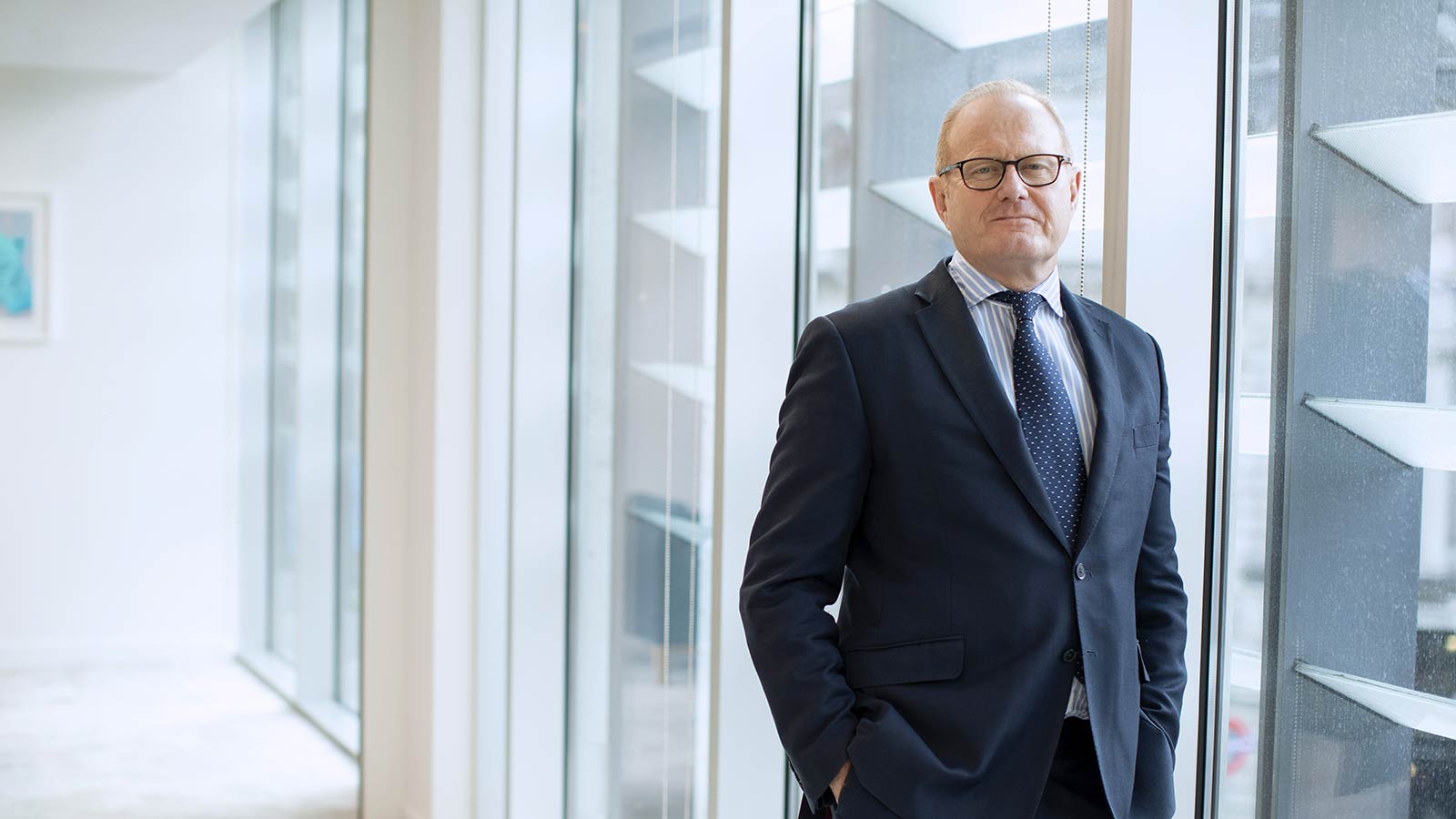 Managing Director and founding partner Louis Young standing and posing in business suit in Augusta London office with hands in his pockets