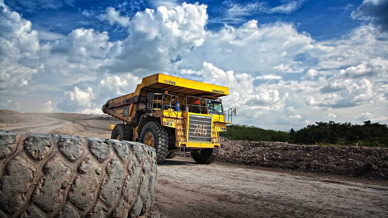 Mining truck driving through desolate landscape