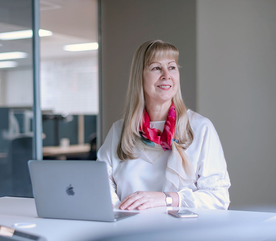 Augusta Ventures Chief Executive Officer CEO Mira Brennan sitting in the Sydney Australia office looking out of window smiling