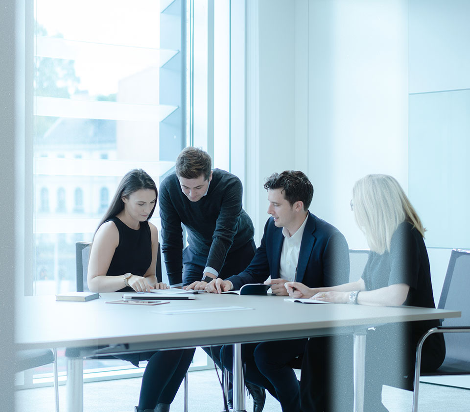 Team meeting in Augusta London office boardroom with female and male solicitors and lawyers Paula Cox, Liam Petch and Investment managers David Walker and Alicia Wilson